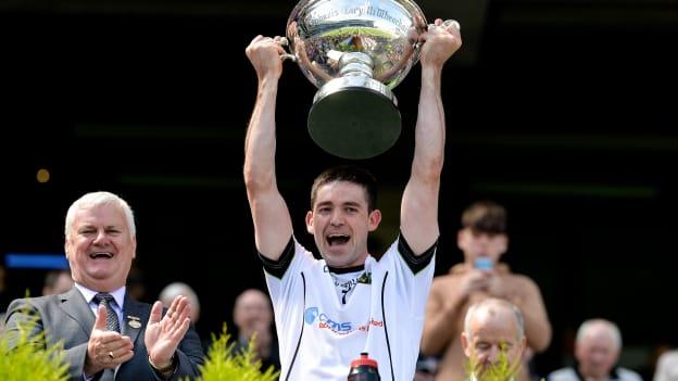 Warwickshire captain Donncha Kennedy lifts the Lory Meagher Cup.