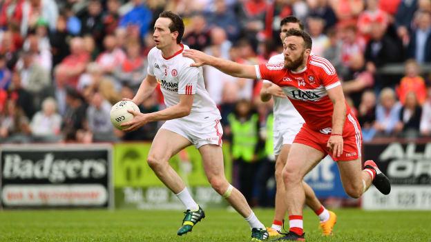 Colm Cavanagh, Tyrone, and Emmett McGuckin, Derry, during the Ulster SFC Quarter Final at Celtic Park.