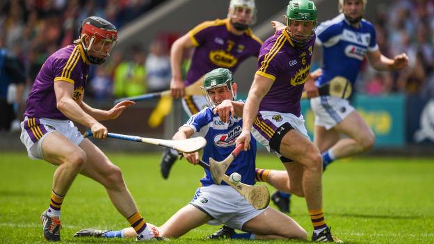 Diarmuid O Keefe and Matthew O Hanlon, Wexford, and Sean Downey, Laois, in action at O Moore Park.