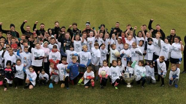 The PwC Football All-Stars pose for a picture with some of the children they coached at the Limerick Fields GAA complex. 