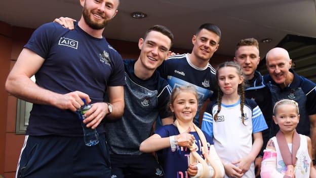 Dublin footballers, from left, Jack McCaffrey, Brian Fenton, Brian Howard, and Paddy Small, and selector Paul Clarke with children during the All-Ireland Senior Football Champions visit to Our Lady's Children's Hospital, Crumlin in Dublin. 