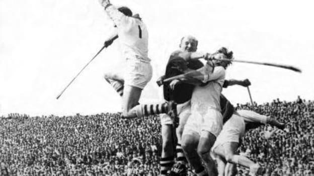 Waterford goalkeeper Ned Power rises high to catch the ball above Cork's Christy Ring in the 1962 Munster SHC semi-final.