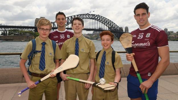 Gearóid McInerney, right, and Niall Burke, Galway, with Padraig Frewen, Finn Lavelle, and Aidan Collins, pupils of the local St Ignatius College, in Sydney Harbour prior to the Wild Geese Cup in Sydney. Circular Quay, New South Wales, Australia.