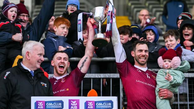 Ruairí Óg captain Neil McManus, right, with daughter Aoibhinn, age 1, and vice-captain Ryan McCambridge lift the cup after the AIB Ulster GAA Hurling Senior Club Championship final match between Ruairi Óg, Antrim, and Slaughtneil, Derry, at Páirc Esler in Newry, Down. Photo by Ben McShane/Sportsfile