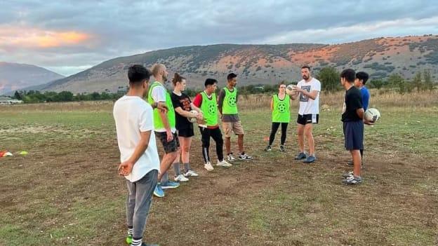 Alexandre San Martin Costa pictured explaining some of the skills of Gaelic football to refugees in Katsikas camp. 
