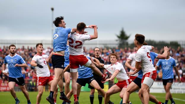 Michael Darragh MacAuley, Dublin, and Declan McClure, Tyrone, collide during the All Ireland SFC Quarter Final Group Phase clash at Healy Park, Omagh.