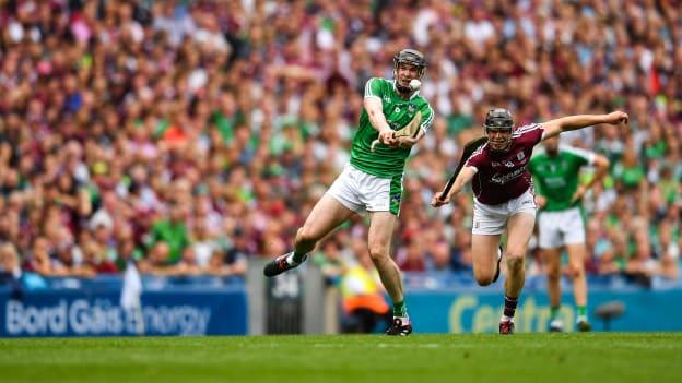 Declan Hannon of Limerick scores a point despite the attention of Joseph Cooney of Galway during the 2018 GAA Hurling All-Ireland Senior Championship Final match between Galway and Limerick at Croke Park in Dublin. 