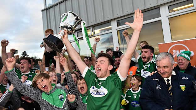 Gaoth Dobhair's Niall Friel raises the Maguire Cup at MacCumhaill Park.