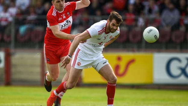 Ronan McNamee, Tyrone, and Ryan Bell, Derry, collide at Healy Park.