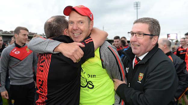 Eamonn Burns celebrates with fans and Down Chairman Sean Rooney, right, after managing Down to victory over Monaghan in the 2017 Ulster SFC semi-final. 