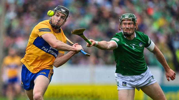 Tony Kelly of Clare scores a point despite the best efforts of William O'Donoghue of Limerick during the Munster GAA Hurling Senior Championship Final match between Limerick and Clare at FBD Semple Stadium in Thurles, Tipperary.