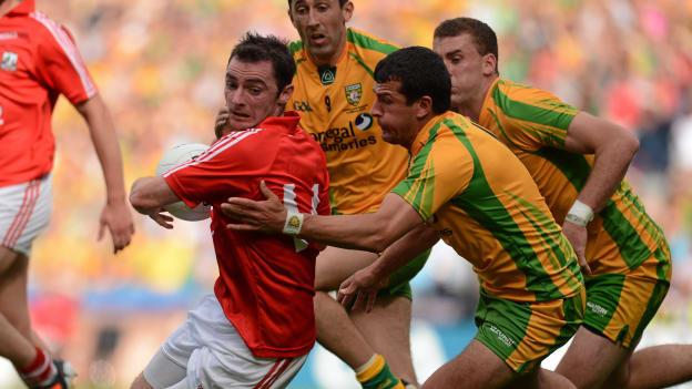 Donnacha O Connor, Cork, surrounded by Donegal players Rory Kavanagh, Eamonn McGee, and Frank McGlynn in the 2012 All Ireland SFC Semi-Final.