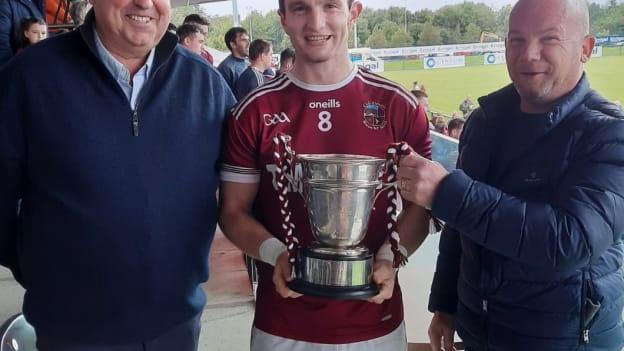 Slaughtneil captain Cormac O’Doherty with the Fr Collins Cup, alongside Kieran Leadon of Leadon Timberframe and Derry GAA Chairperson John Keenan. Photo: Derry GAA.