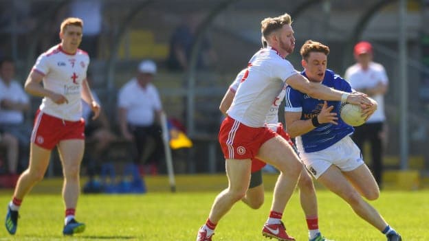 Ciaran Brady, Cavan, and Frank Burns, Tyrone, collide at Brewster Park.