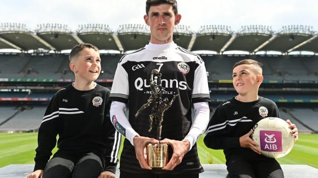 Kilcoo footballer Eugene Branagan with his AIB GAA club footballer of the year award and nephews Pat Branagan, aged 9, left, and Jonjo Branagan, aged 8, during the AIB GAA Club Players’ Awards 2021/22 at Croke Park in Dublin. 