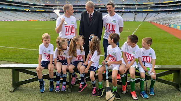 #hurlthehabit ambassadors, from left, former Cork hurler Joe Deane, former commentator Mícheál Ó Muircheartaigh, and former Waterford hurler Tony Browne, with children from the Killeagh GAA club, Co Cork, and St Colmcilles, GAA club, Co Meath at Croke Park. 