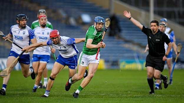 Referee Colm Lyons plays advantage as David Reidy of Limerick is tackled by Tadhg De Búrca of Waterford during the 2020 Munster GAA Hurling Senior Championship Final match between Limerick and Waterford at Semple Stadium in Thurles, Tipperary. 