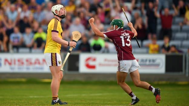 Evan Niland of Galway celebrates scoring his side's third goal as Aaron Maddock of Wexford looks ON dejected during the Bord Gais Energy Leinster Under 21 Hurling Final.