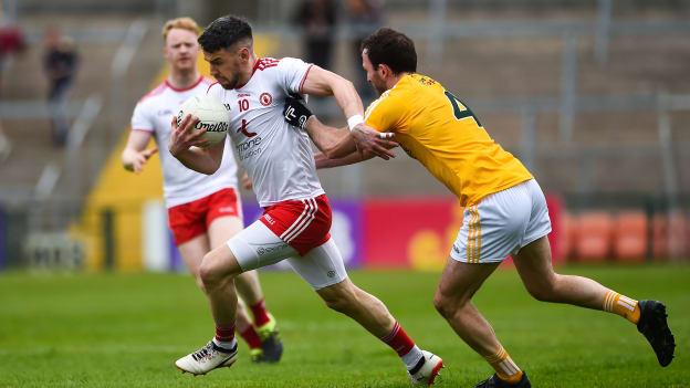 Mattie Donnelly, Tyrone, and Patrick Gallagher, Antrim, during the Ulster SFC Quarter-Final at the Athletic Grounds.