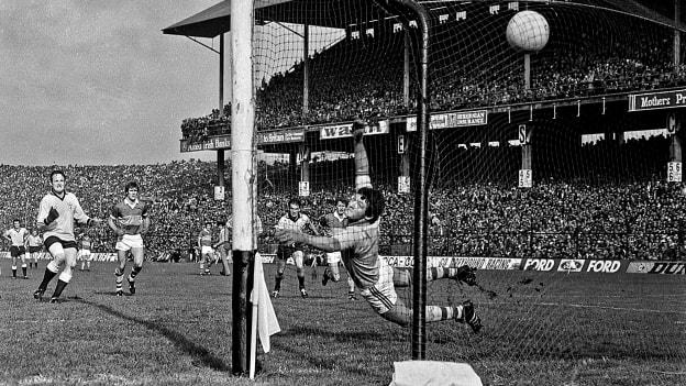 Dublin's Jimmy Keavney shoots past Kerry goalkeeper Charlie Neligan to score his side's goal. All-Ireland Football Final, Dublin v Kerry, Croke Park, Dublin. 