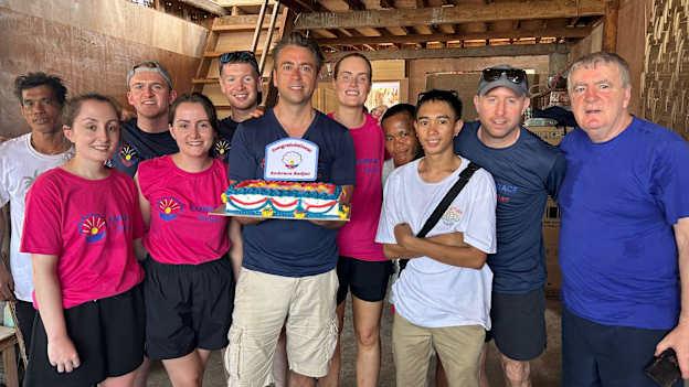 Richard Hogan, centre, and the volunteers from Kildalkey and Boardsmill GAA club members celebrate the construction of the school for the Badjao tribe. 