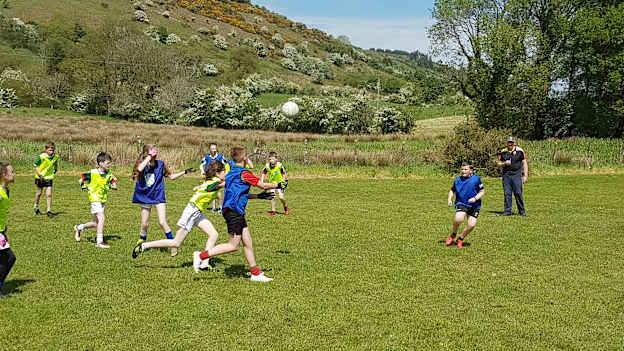 Boys and girls from Craggagh National School playing in the steep slopes of Sliabh Cairn in Balla, County Mayo.