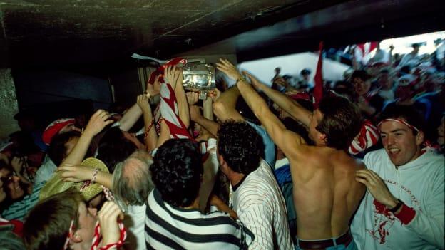 Cork supporters gather around the Liam MacCarthy Cup under the Hogan Stand after victory over Galway in the 1990 All-Ireland SHC Final. 