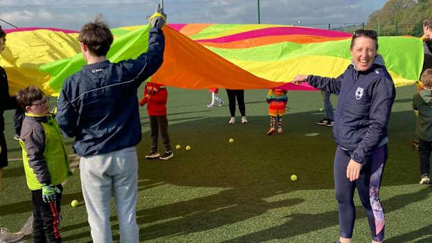 Blessington All-Stars coaches and players get their multi-coloured parachute into action. 