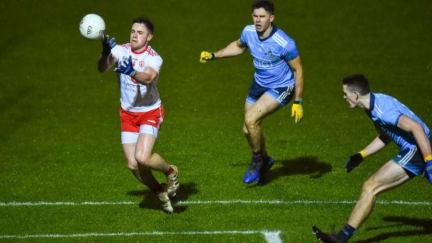 Liam Rafferty on the ball for Tyrone with Dublin's David Byrne and Brian Fenton.