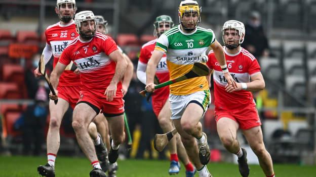 Shane Kinsella of Offaly in action against, from left, Séan O Caiside, Mark Craig and Eamon McGill of Derry during the Christy Ring Cup Round 2B match between Derry and Offaly at Páirc Esler in Newry, Down. 