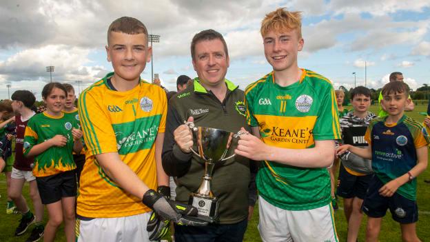 Cathaoirleach John West Féile,Diarmuid Ó Cathail, presents Claregalway captains Jamie King and Sean O’Callaghan with the Division 1 Cup after Claregalway defeated Austin Stacks (Kerry) in the final at the John West Féile Peile na nÓg National Gaelic and Ladies football finals 2022 at the GAA National Games Development Centre Campus, Abbotstown, Dublin, Eighty-eight club sides from Ireland, the UK, Europe and US competed in the final stages of the under-15 competition across nine venues, one of the biggest underage sporting events on the continent, sponsored for the seventh time by John West.
