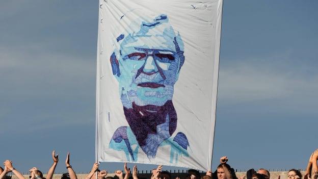 Dublin fans with a flag in honour of the late Kevin Heffernan on Hill 16 before the 2013 GAA Football All-Ireland Championship Final. 