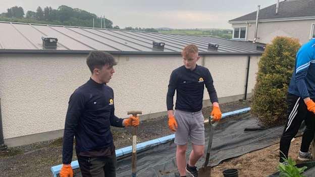 Felix Foley, left, and Luke Coyle planting trees at Strabane Sigerson's club grounds as part of the Dermot Earley Youth Leadership Initiative. 