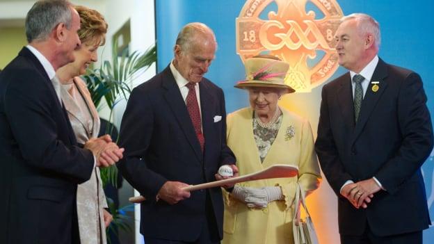 HRH the Duke of Edinburgh examines a hurley and sliothar which was presented to him by Uachtarán CLG Criostóir Ó Cuana in the presence of President Mary McAleese, her husband Dr. Martin McAleese, and HM Queen Elizabeth II during their tour of Croke Park. 