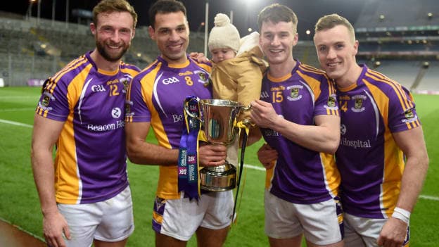 Kilmacud Crokes players, left to right, Shane Horan, Craig Dias, Craig's daughter Lola, Dara Mullin, and Shane Cunningham celebrate after the AIB Leinster GAA Football Senior Club Championship Final match between Kilmacud Crokes and Naas at Croke Park in Dublin.