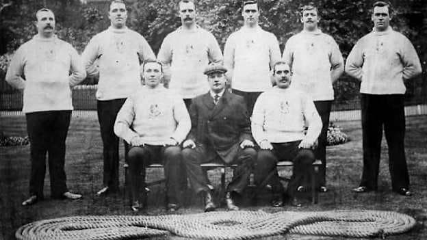 Edwart Barrett, seated front left, as part of the 1908 British Tug of War team.