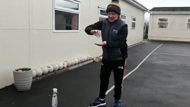 Ulster GAA coach, Kevin Curran, applying hand sanitiser before coaching the children of St. Peter's Primary School, Collegeland, in Armagh. 