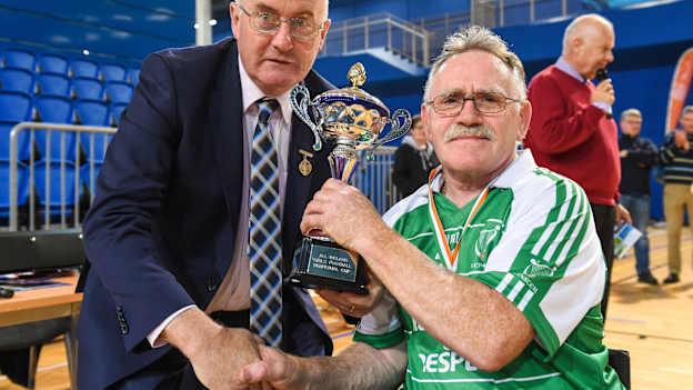 Uachtarán Cumann Lúthchleas Gael John Horan presents Leinster captain Sean Bennett with the Inter Provincial tournament trophy following the 2018 M.Donnelly GAA Wheelchair Hurling All-Ireland Finals match between Munster and Leinster at the Sport Ireland National Indoor Arena in Abbotstown, Dublin.