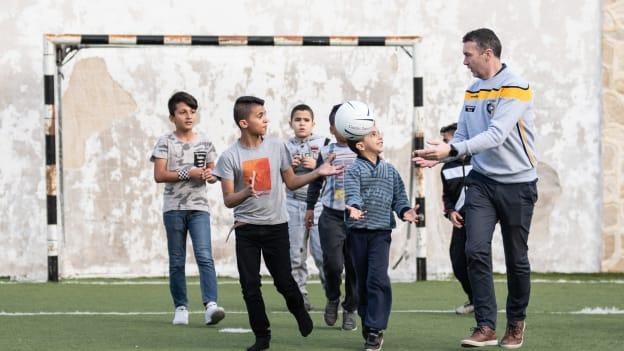 Wicklow senior football team manager and former Armagh footballer, Oisín McConville, pictured playing Gaelic football with young Palestinian refugees in the Aida refugee camp in Bethlehem.
