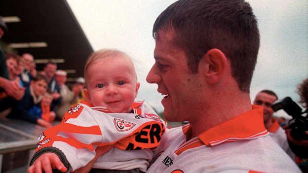 Derry captain Anthony Tohill with his son Anton following his side's victory during the 2000 Church & General National Football League Final Replay match between Derry and Meath at St Tiernach's Park in Clones, Monaghan. Photo by David Maher/Sportsfile.