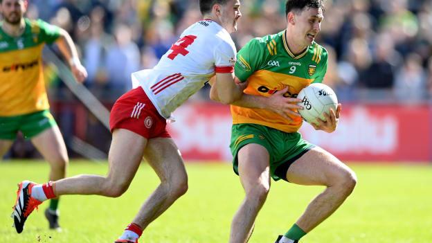 Michael Langan of Donegal is tackled by Darragh Canavan of Tyrone during the 2024 Ulster GAA Football Senior Championship semi-final match between Donegal and Tyrone at Celtic Park in Derry. Photo by Stephen McCarthy/Sportsfile