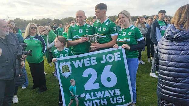 Joe Hegarty's parents Michael and Andrea, and sister Katie, pictured with Carey Faughs captain Shea Hunter after the club's Antrim Intermediate Hurling Final success. 