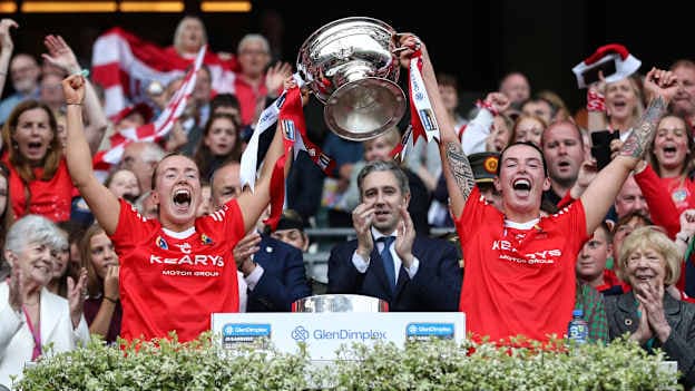 Cork's Laura Treacy and Ashling Thompson lift the Sean O’Duffy Cup after victory over Galway in the 2024 Glen Dimplex All-Ireland Senior Camogie Final. Mandatory Credit ©INPHO/Ben Brady
