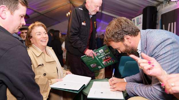 Edwin McGreal signing copies of his recently published book, Our Finest Hour.