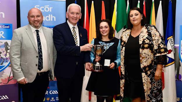 Eimear Magee, ó CLG Dhroichead Mhaigh Eo, being presented with her Ulster medal by Ulster GAA President, Michael Geoghegan and Philip McGovern, Ulster Scór Secretary and Bronagh Lennon, Ulster Scór Chairperson