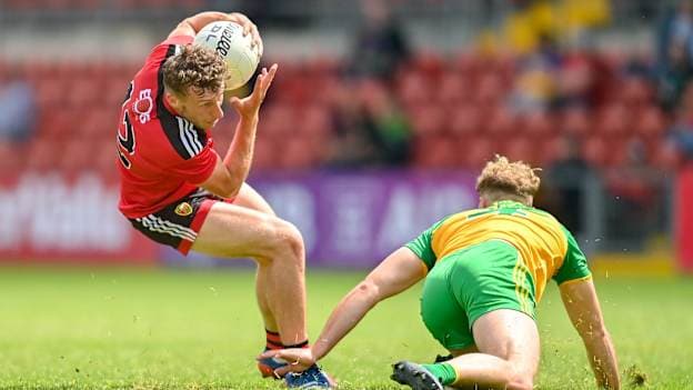 Barry O'Hagan of Down evades the tackle of Stephen McMenamin of Donegal during the Ulster GAA Football Senior Championship Preliminary Round match between Down and Donegal at Páirc Esler in Newry, Down. Photo by Ramsey Cardy/Sportsfile.