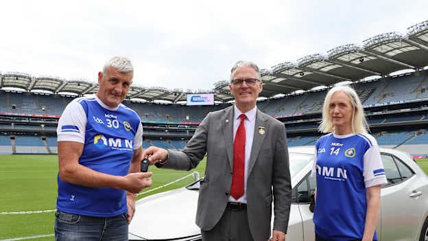 2026 GAA National Club Draw first prize winner, Dermott McConnall, and his wife Eibhlin, pictured getting the keys of their new Toyota Corolla Hybrid from GAA President, Jarlath Burns. 