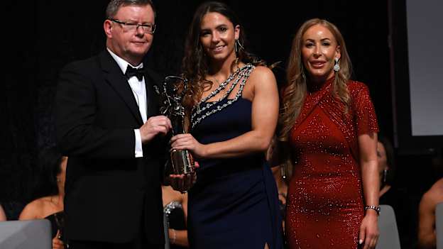 Camogie Association Uachtaran Brian Molloy, Saoirse McCarthy of Cork and Marie Coady, PwC Markets Partner pictured at the 2025 PwC Camogie All-Stars Awards night. 