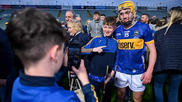 Senan Butler of Tipperary stands for a photo with a supporter after the 2024 oneills.com Munster GAA U20 Hurling Championship final match between Tipperary and Cork at TUS Gaelic Grounds. Photo by Ben McShane/Sportsfile
