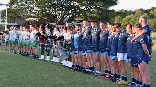 The Cairns Chieftains and Four Mile GAC players line up for the national anthem at the recent Carpenter Cup tournament. 
